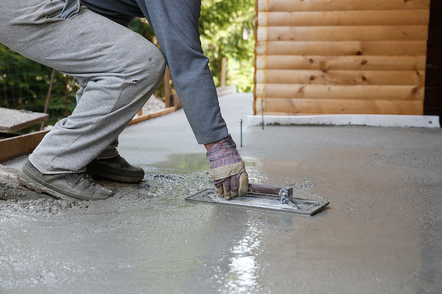 man flattening the concrete cement