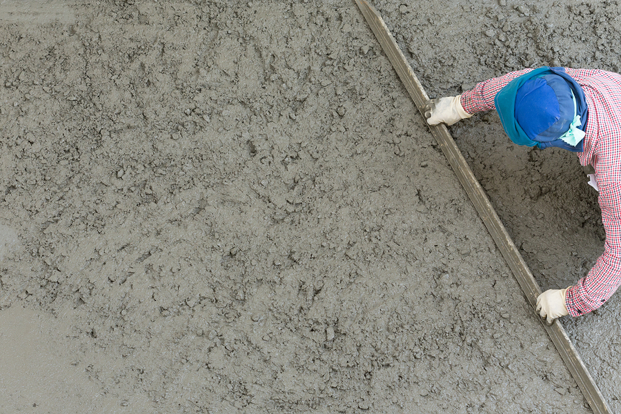 man flattening the cement