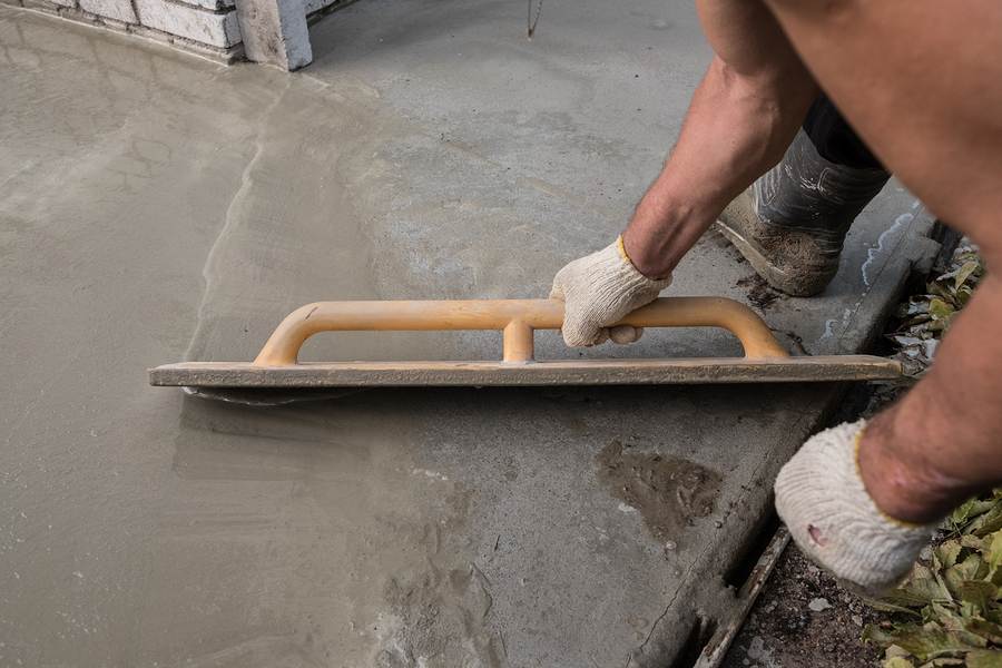 man flattening the concrete cement